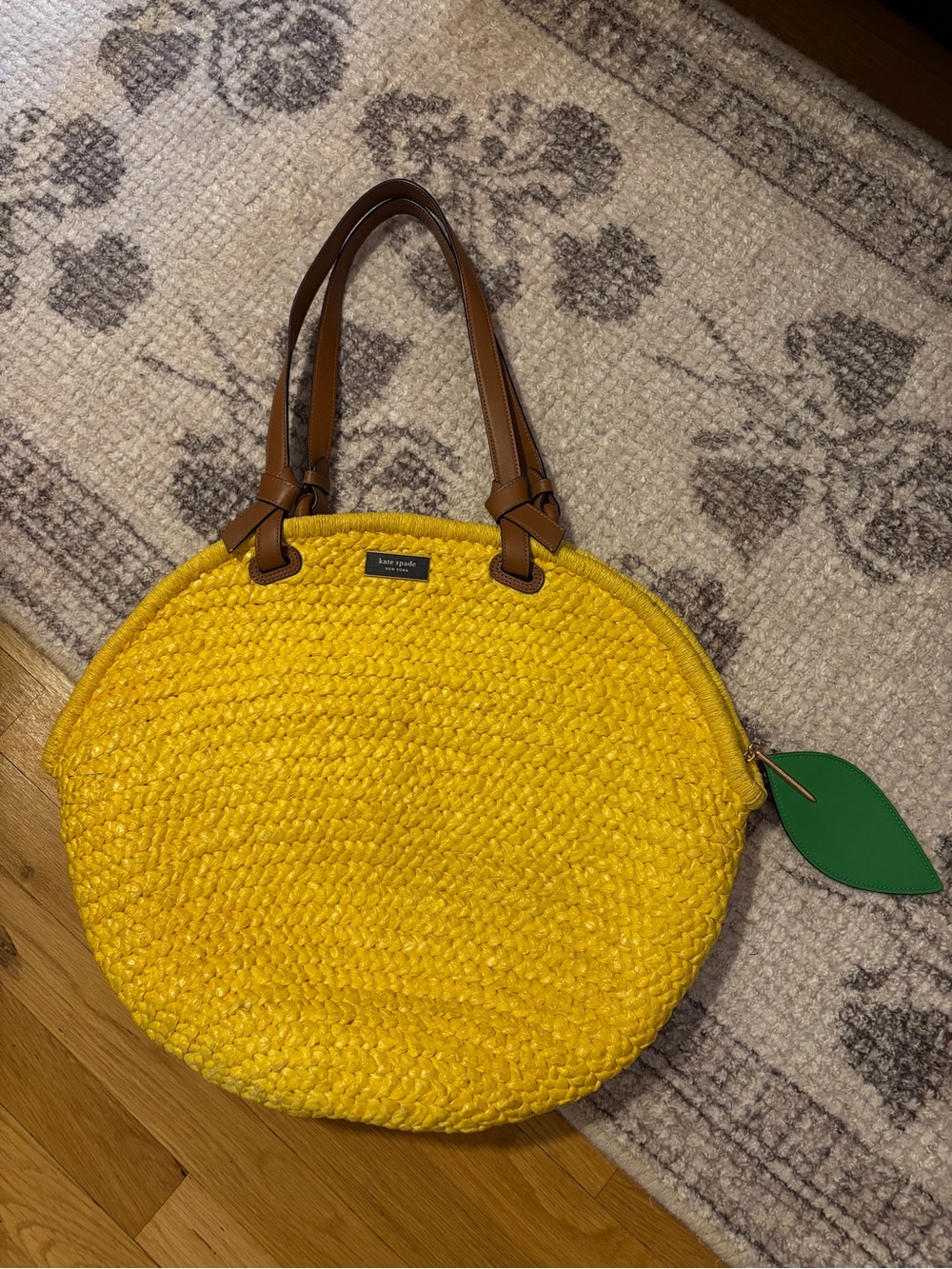 Kate Spade New York yellow lemon woven straw tote bag with brown leather handles